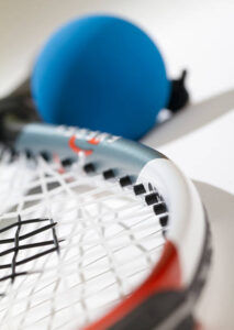 close pic of ball and side of racquet